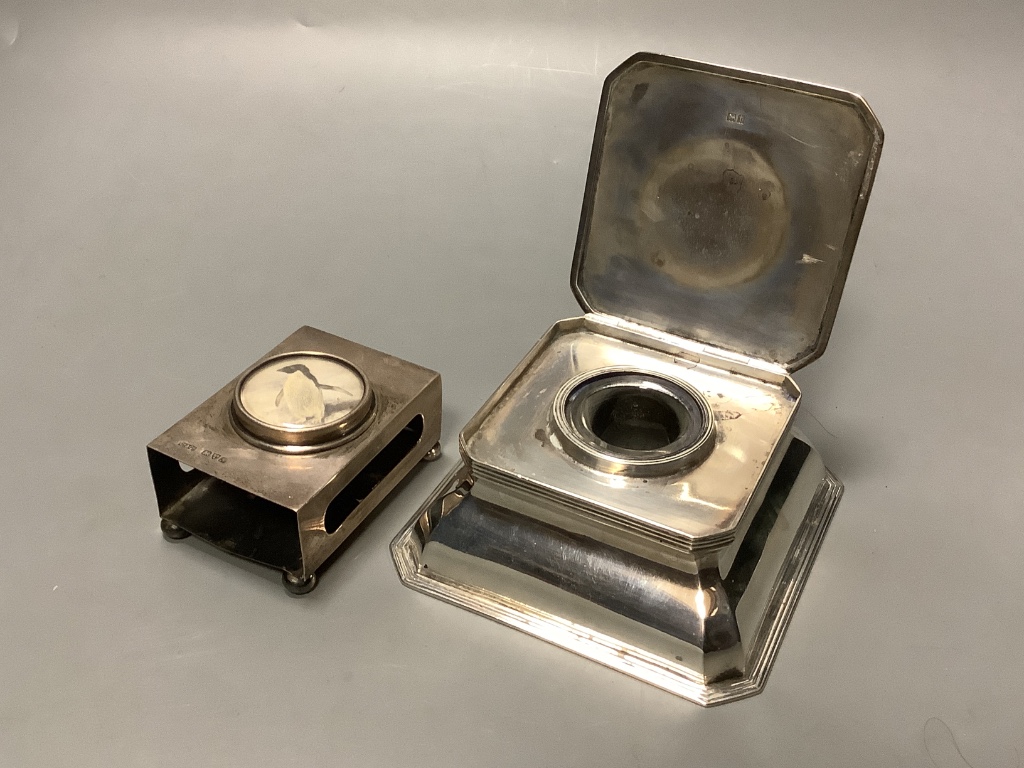 A George V silver mounted cut glass inkwell, goldsmiths and silversmiths Co Ltd, London 1914, 11.4cm and a silver matchbox sleeve.